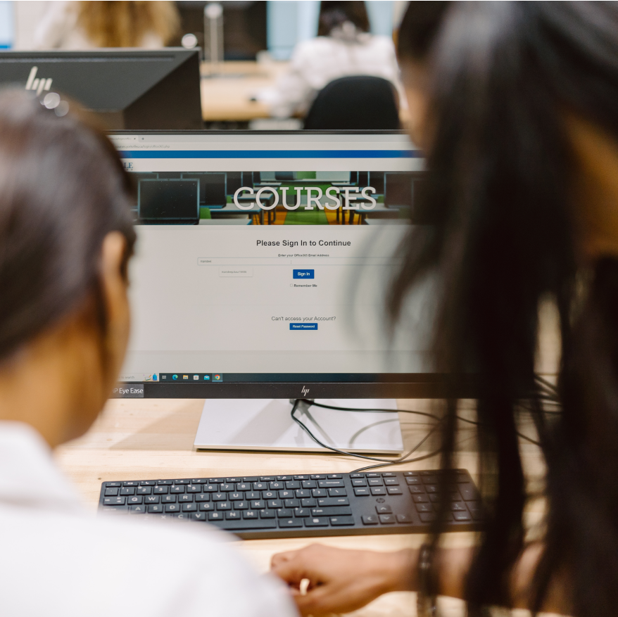 Students looking at laptop screen